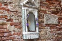 Outdoor shrine embedded in a wall in Venice Photo by Margie Miklas